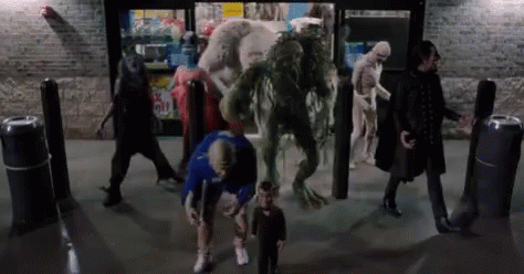 A Group Of People Are Standing In Front Of A Store With Monsters Coming Out Of The Door . GIF