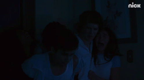 A Group Of People Are Standing In Front Of A Wall With A Nick Logo On It GIF