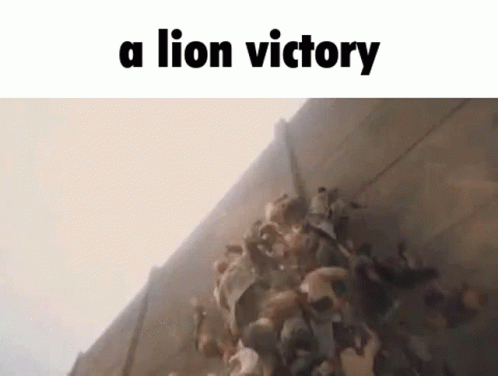 A Group Of People Are Standing In Front Of A Wall With The Words `` A Lion Victory '' Written On It . GIF
