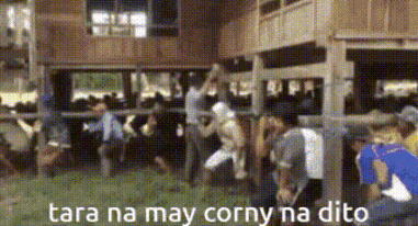 A Group Of People Are Standing In Front Of A Wooden Building With The Words Tara Na May Corny Na Dito On The Bottom GIF