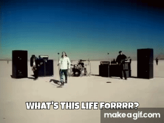 A Group Of People Are Standing In The Middle Of A Desert In Front Of Speakers . GIF