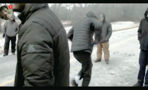 A Group Of People Are Standing In The Snow With The Number 1 In The Corner GIF