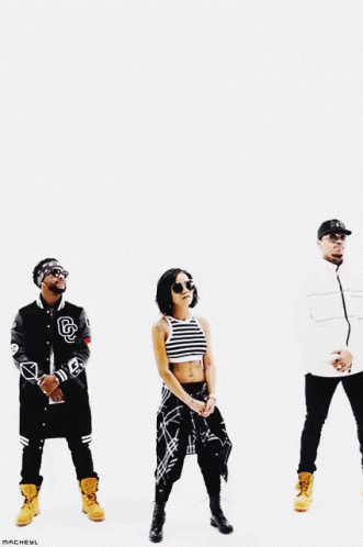 A Group Of People Are Standing Next To Each Other And One Of Them Has The Letter B On His Jacket GIF
