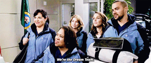 A Group Of People Are Standing Next To Each Other And One Of Them Is Holding A Bag And Saying We 'Re The Dream Team GIF