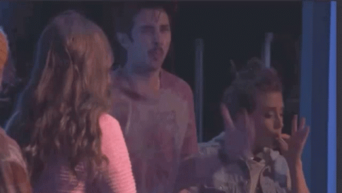 A Group Of People Are Standing Next To Each Other And One Of Them Is Saying You 'Re Either In The Smoke Club GIF