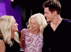 A Group Of People Are Standing Next To Each Other And Smiling . GIF