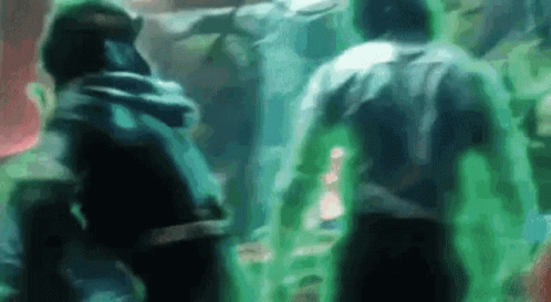 A Group Of People Are Standing Next To Each Other In A Dark Room With Green Lights Coming Out Of Them . GIF