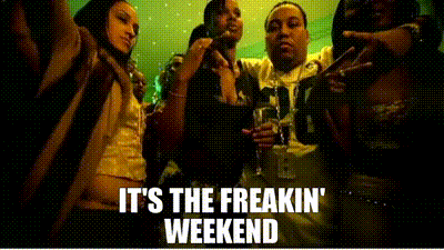 A Group Of People Are Standing Next To Each Other In A Dark Room . GIF