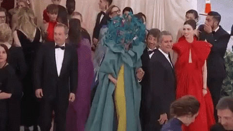 A Group Of People Are Standing Next To Each Other In A Room At A Party . GIF
