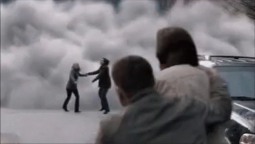A Group Of People Are Standing Next To Each Other In Front Of A Cloudy Sky . GIF