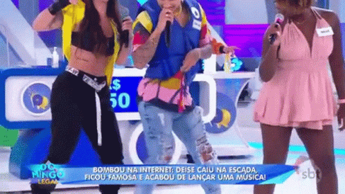 A Group Of People Are Standing Next To Each Other On A Stage With Microphones . GIF
