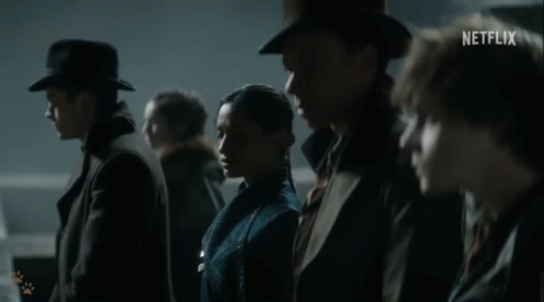 A Group Of People Are Standing Next To Each Other With A Netflix Logo In The Corner GIF