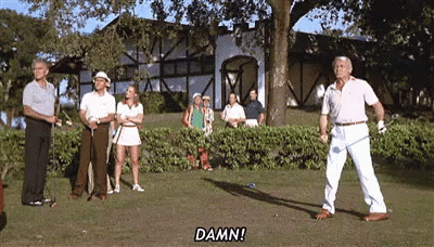A Group Of People Are Standing On A Golf Course Watching A Man Swing His Golf Club . GIF