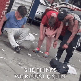 A Group Of People Are Standing On A Sidewalk And One Of Them Is Kneeling Down . GIF