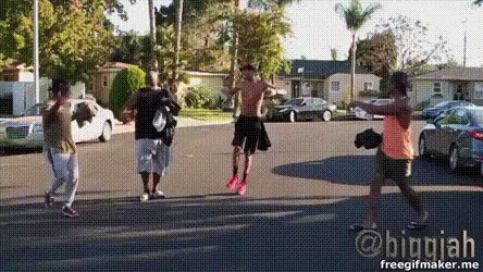 A Group Of People Are Standing On A Street With A Watermark That Says Biggiah GIF