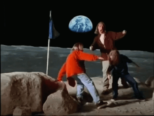 a group of people are standing on the moon with a flag in the background .