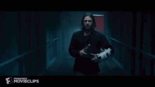 A Group Of People Are Walking Down A Dark Hallway With A Fandango Movieclips Logo On The Bottom GIF