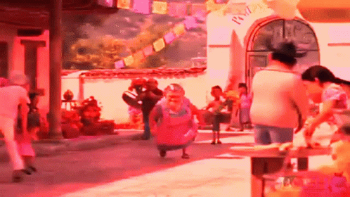 A Group Of People Are Walking Down A Street In Front Of A Building With A Sign That Says " Welcome " On It GIF