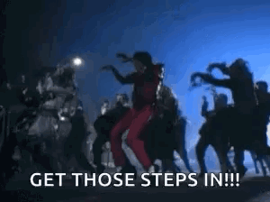 A Group Of People Are Walking Down A Street With The Words `` Get Those Steps In '' Written In The Foreground . GIF