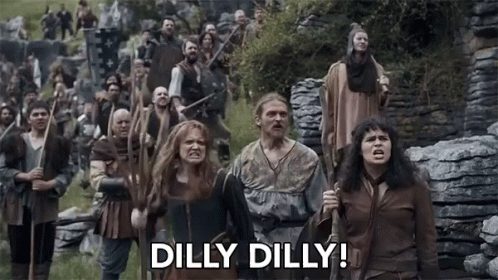 A Group Of People Are Walking In A Field With The Words Dilly Dilly Written On The Bottom . GIF