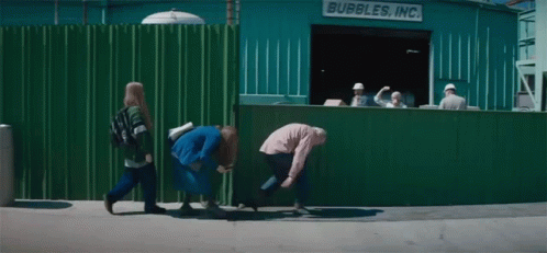 A Group Of People Are Walking In Front Of A Bubbles Inc. Building GIF
