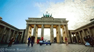 People Walking In Front Of Deutsch Sign GIF