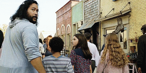 A Group Of People Are Walking In Front Of A Shoe Repair Shop GIF
