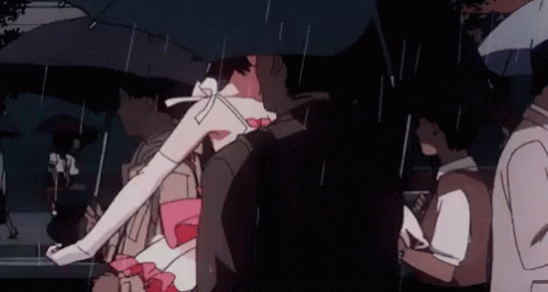 A Group Of People Are Walking In The Rain Under An Umbrella . GIF