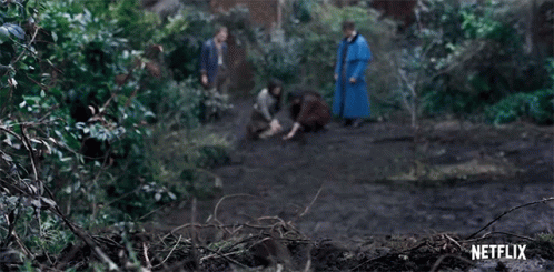 A Group Of People Are Walking Through A Forest With A Netflix Logo In The Background . GIF