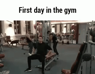 A Group Of People Are Working Out In A Gym . GIF