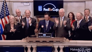 A Group Of People Clapping In Front Of A Screen That Says Fedexcup GIF