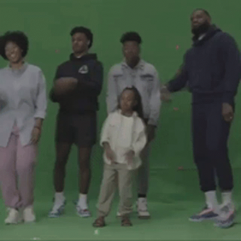 A Group Of People Dancing On A Green Screen GIF