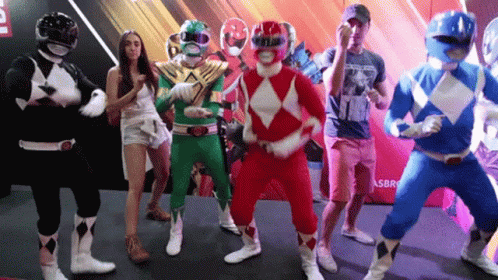 A Group Of People Dressed As Power Rangers Are Dancing Together GIF