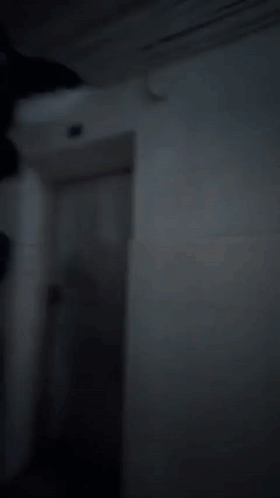 a group of people dressed as tom and jerry are walking down a dark hallway