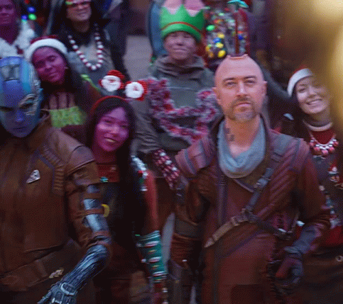 A Group Of People Dressed In Costumes Including One Wearing A Crown GIF