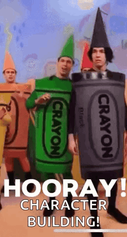 A Group Of People Dressed In Crayon Costumes Are Standing In Front Of A Building That Says Hooray ! Character Building ! GIF