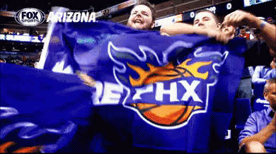 A Group Of People Holding A Blue Arizona Flag GIF