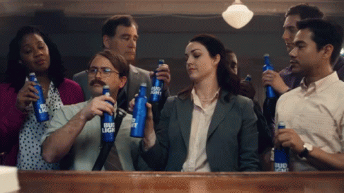A Group Of People Holding Bud Light Bottles In Their Hands GIF