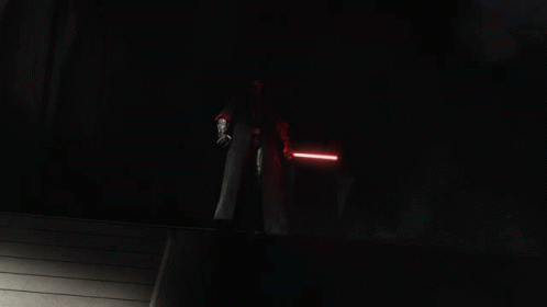 A Group Of People Holding Lightsabers In A Dark Room GIF
