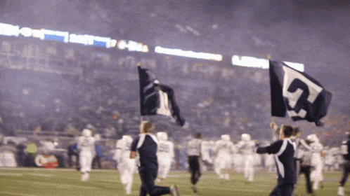 a group of people holding up flags with the number 5 on them