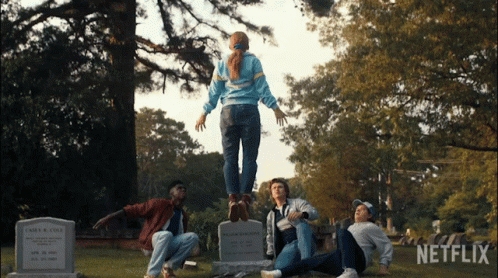 A Group Of People In A Cemetery With Netflix Written On The Bottom GIF