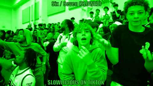 A Group Of People In A Green Room With The Words Six / Seven Slowed GIF