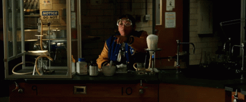 A Group Of People In A Lab With The Words " The Computer " On The Table GIF