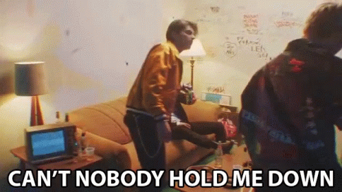A Group Of People In A Living Room With The Words Can 'T Nobody Hold Me Down Written On The Bottom GIF