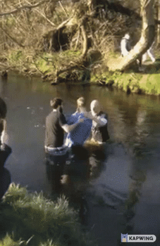 A Group Of People In A River With Kapwing Written On The Bottom Right GIF