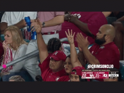 A Group Of People In A Stadium Watching A Football Game Between Oklahoma And Ucla GIF