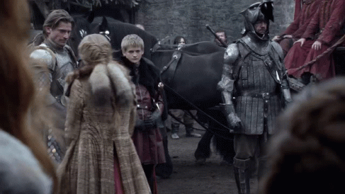 A Group Of People In Armor Are Standing Next To A Horse Drawn Carriage GIF