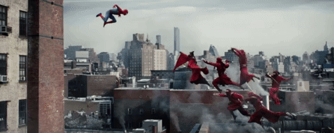 A Group Of People In Red Superhero Costumes Are Flying Through The Air GIF