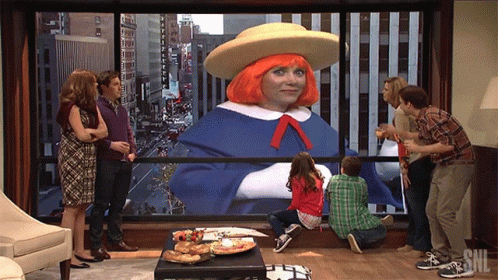 A Group Of People Looking Out A Window With Snl Written On It GIF