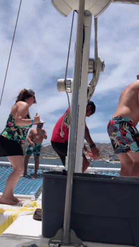 a group of people on a boat including a man in a red shirt and a woman in a floral top